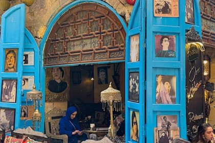 La gente se sienta en el café Umm Kulthum, que lleva el nombre de la fallecida cantante, compositora y actriz de cine egipcia, en la zona histórica de Khan al-Khalili, en el corazón de la capital egipcia, El Cairo, el 28 de enero, antes del 50º aniversario de su muerte