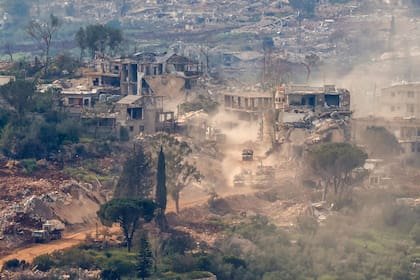 Tanques y vehículos militares israelíes circulando por una ruta entre viviendas destruidas en el sur del Líbano
